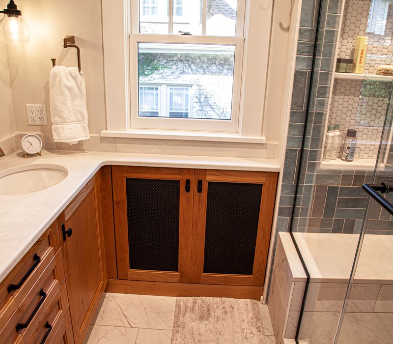 Dark woodwork, patterned terra cotta tile floors, and exposed brick interior walls define the kitchen and addition of this Craftsman home.
