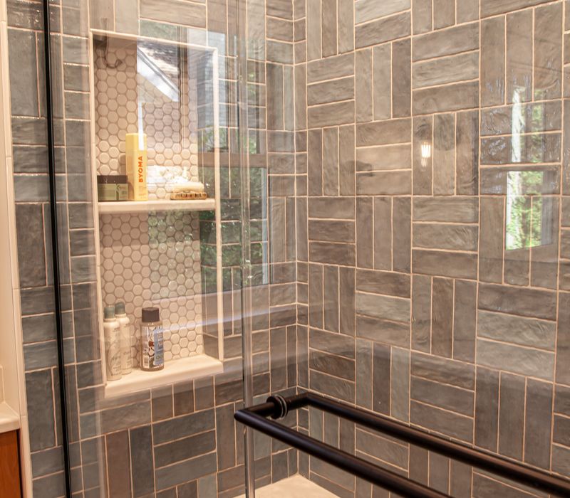 Dark woodwork, patterned terra cotta tile floors, and exposed brick interior walls define the kitchen and addition of this Craftsman home.