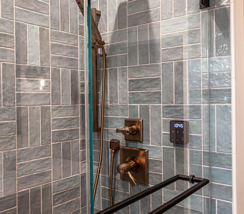 Dark woodwork, patterned terra cotta tile floors, and exposed brick interior walls define the kitchen and addition of this Craftsman home.