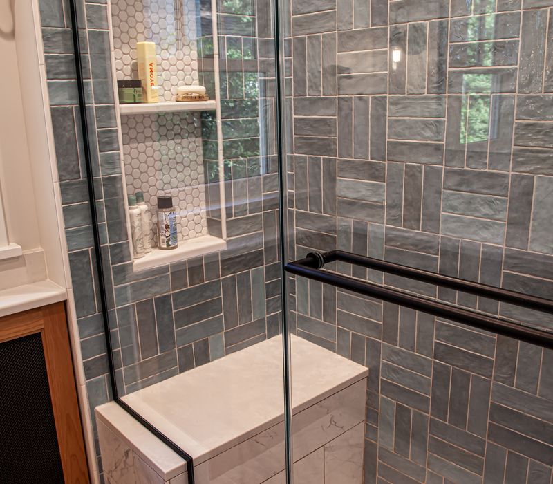 Dark woodwork, patterned terra cotta tile floors, and exposed brick interior walls define the kitchen and addition of this Craftsman home.