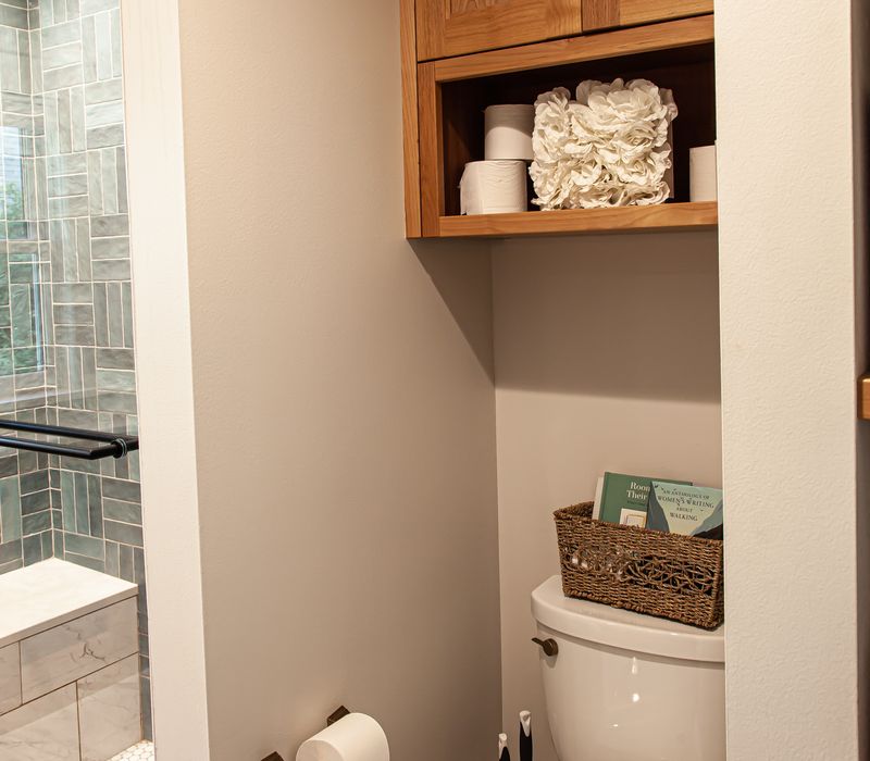 Dark woodwork, patterned terra cotta tile floors, and exposed brick interior walls define the kitchen and addition of this Craftsman home.