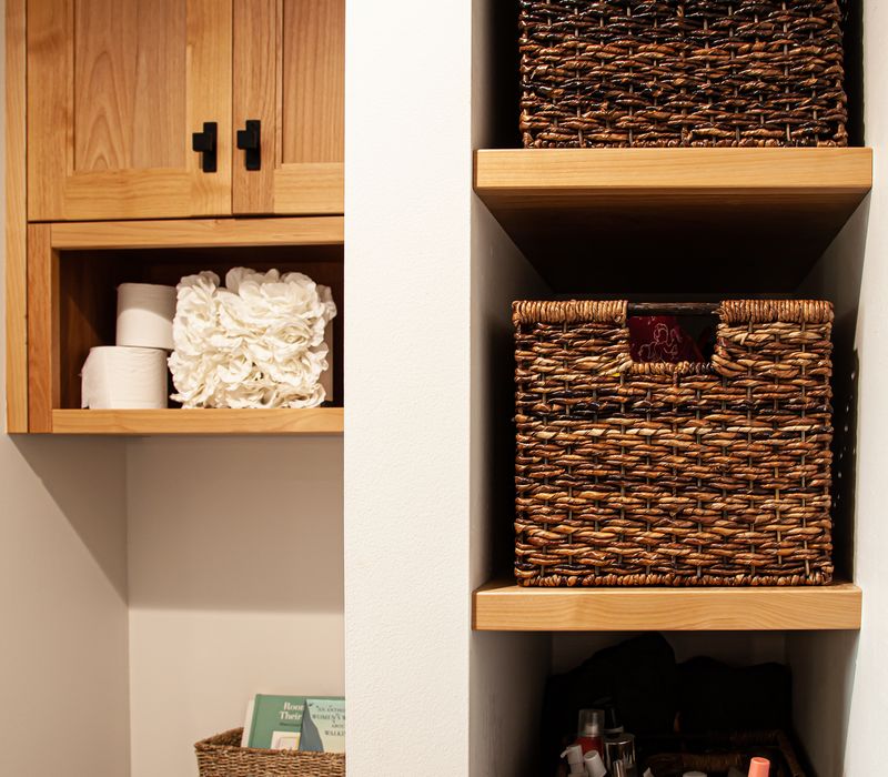 Dark woodwork, patterned terra cotta tile floors, and exposed brick interior walls define the kitchen and addition of this Craftsman home.