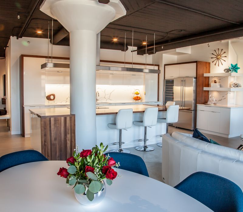 White and stainless steel dominate in this minimalist condo showcasing contemporary artwork. 