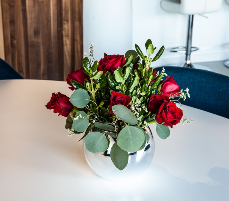 White and stainless steel dominate in this minimalist condo showcasing contemporary artwork. 