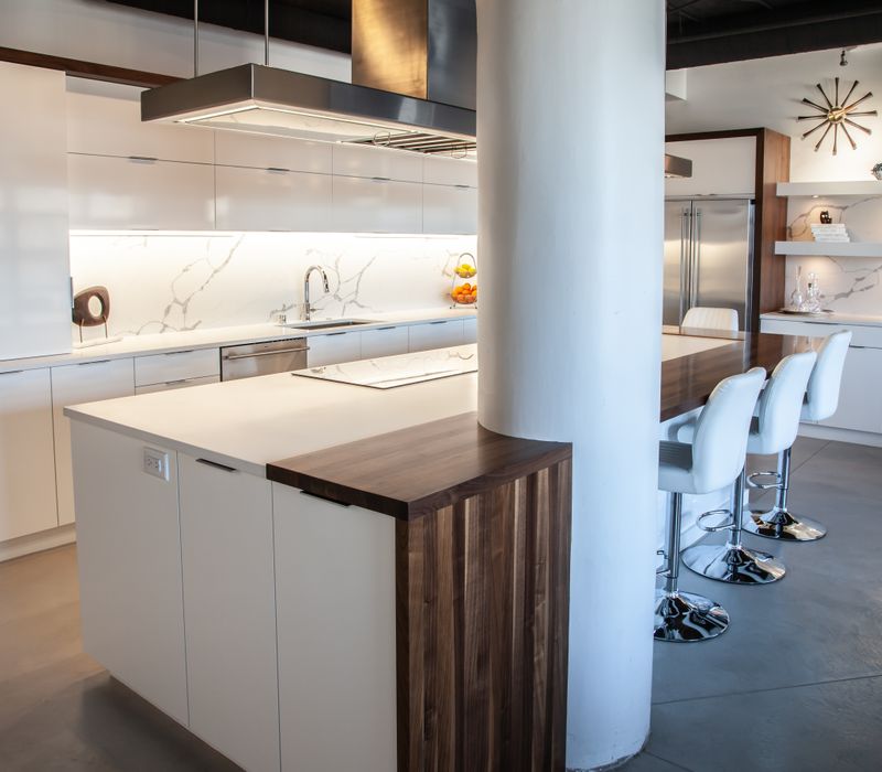 White and stainless steel dominate in this minimalist condo showcasing contemporary artwork. 