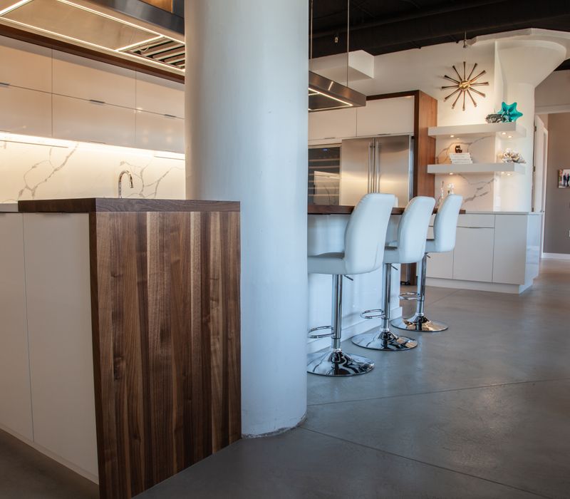 White and stainless steel dominate in this minimalist condo showcasing contemporary artwork. 