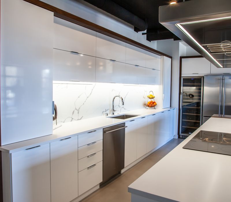 White and stainless steel dominate in this minimalist condo showcasing contemporary artwork. 