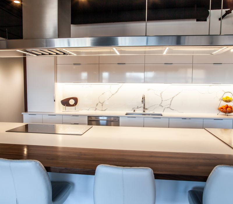 White and stainless steel dominate in this minimalist condo showcasing contemporary artwork. 