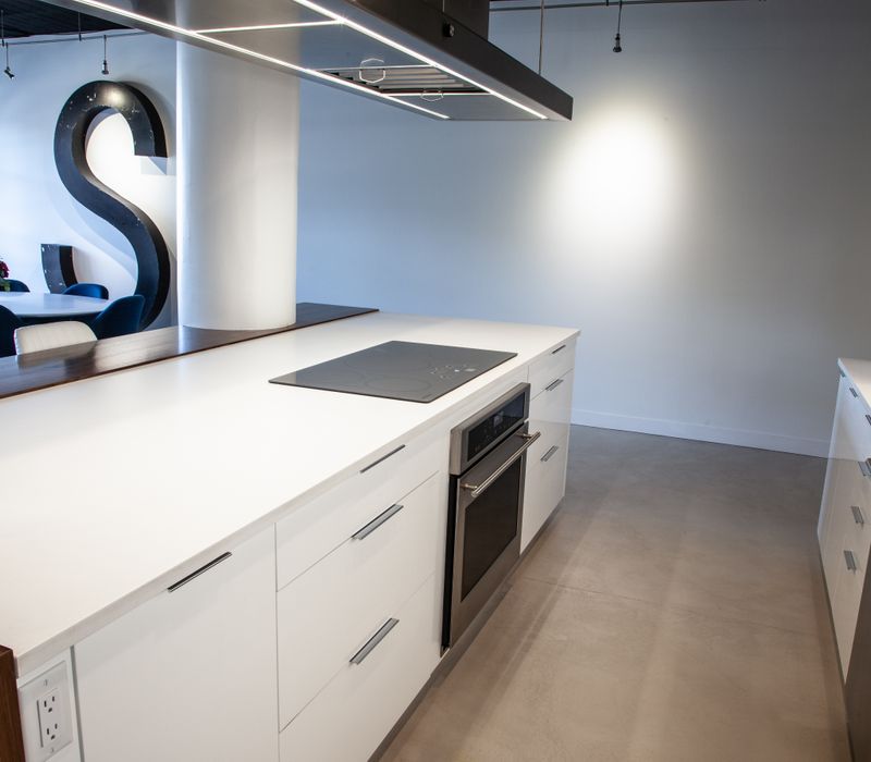 White and stainless steel dominate in this minimalist condo showcasing contemporary artwork. 