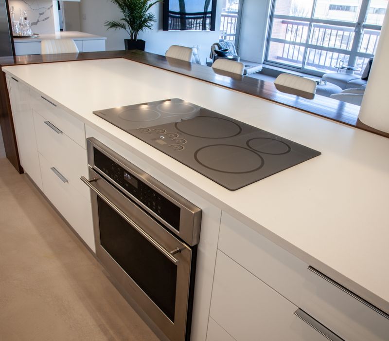 White and stainless steel dominate in this minimalist condo showcasing contemporary artwork. 
