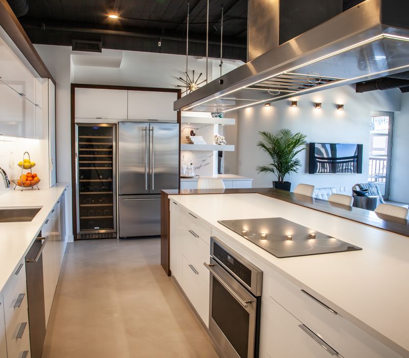 White and stainless steel dominate in this minimalist condo showcasing contemporary artwork. 