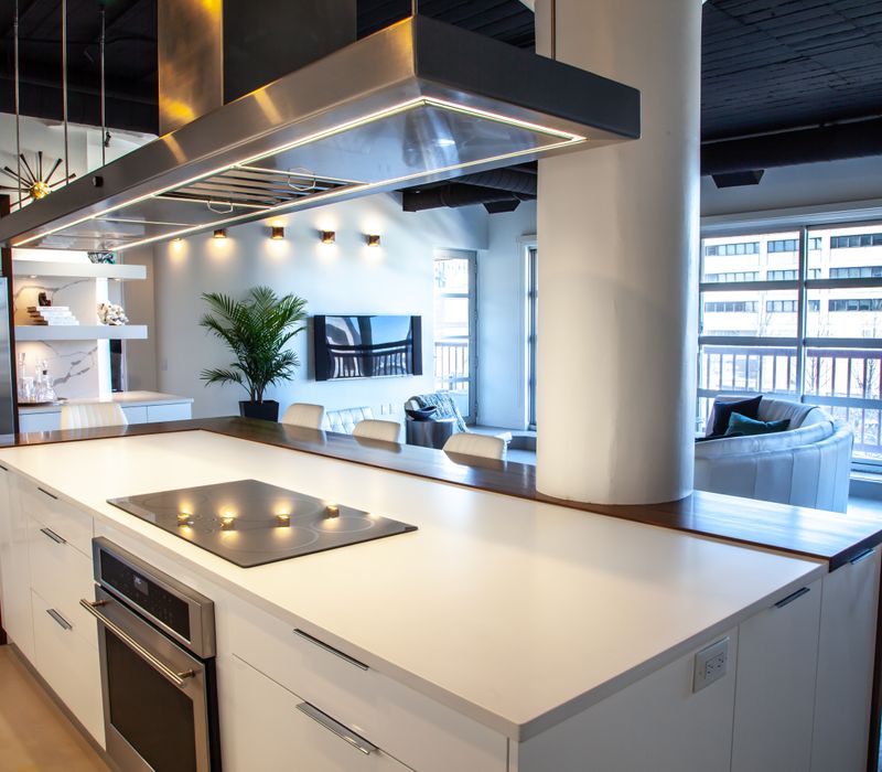 White and stainless steel dominate in this minimalist condo showcasing contemporary artwork. 