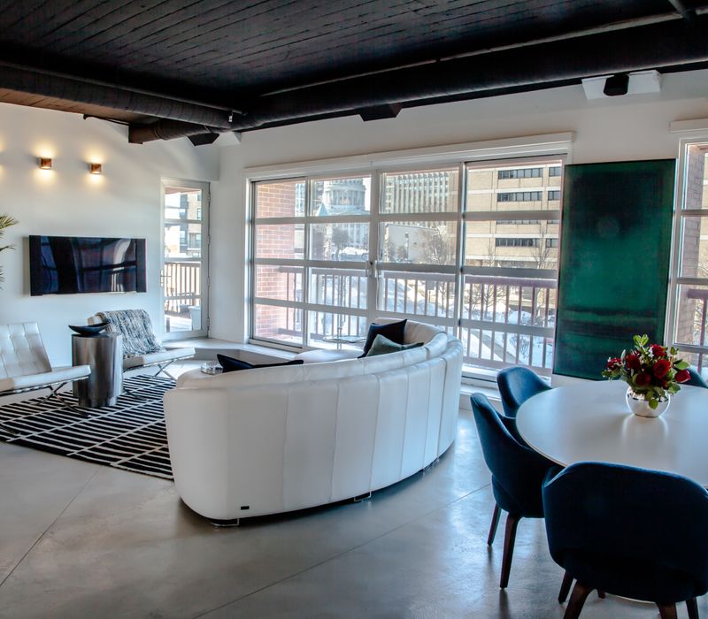 White and stainless steel dominate in this minimalist condo showcasing contemporary artwork. 