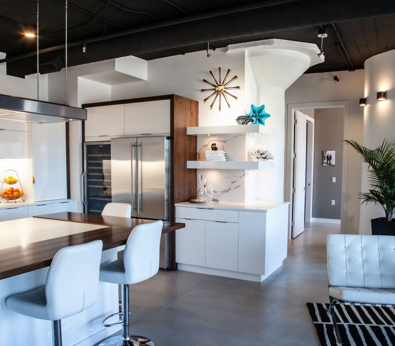 White and stainless steel dominate in this minimalist condo showcasing contemporary artwork. 