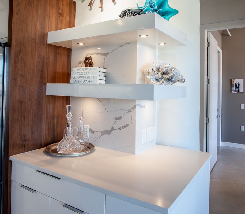 White and stainless steel dominate in this minimalist condo showcasing contemporary artwork. 