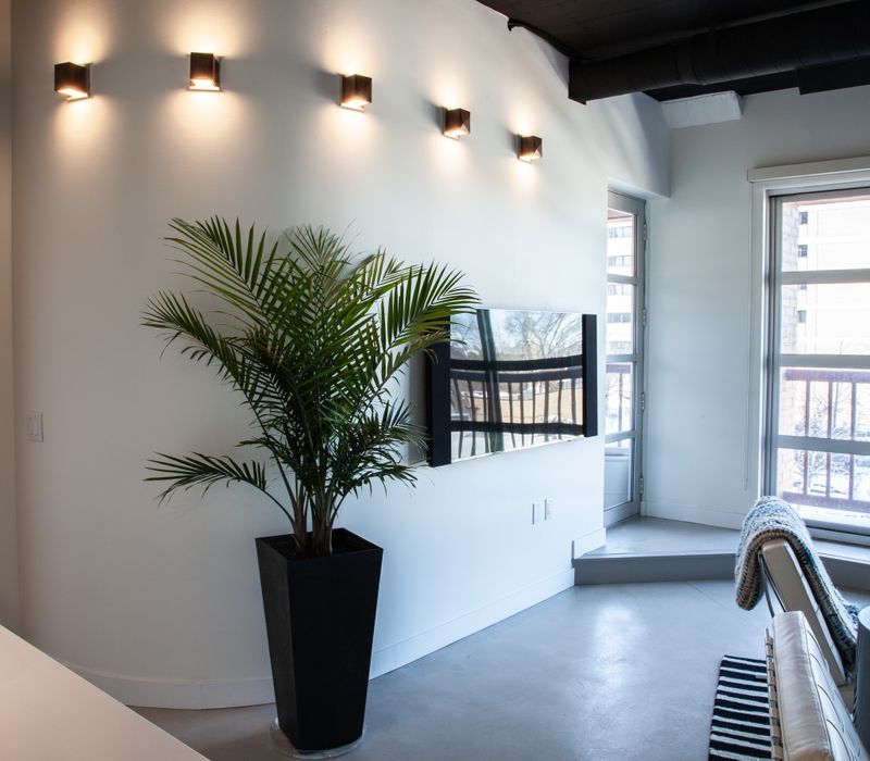 White and stainless steel dominate in this minimalist condo showcasing contemporary artwork. 