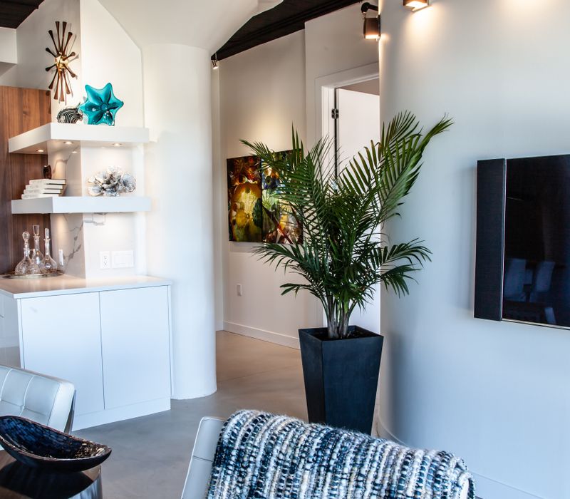 White and stainless steel dominate in this minimalist condo showcasing contemporary artwork. 