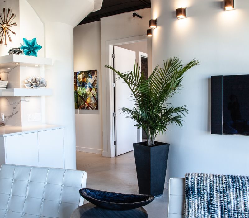 White and stainless steel dominate in this minimalist condo showcasing contemporary artwork. 