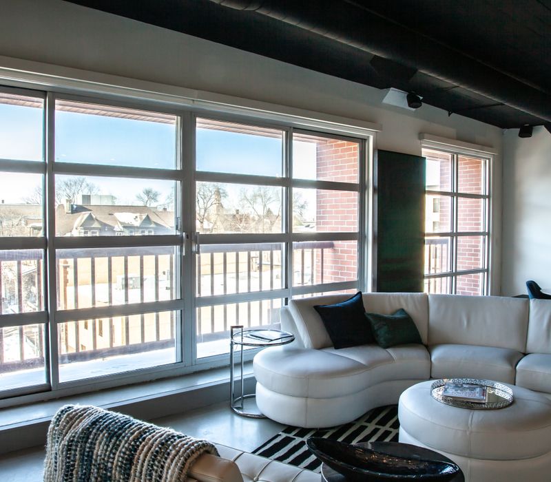 White and stainless steel dominate in this minimalist condo showcasing contemporary artwork. 