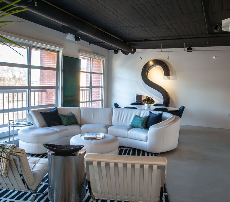 White and stainless steel dominate in this minimalist condo showcasing contemporary artwork. 