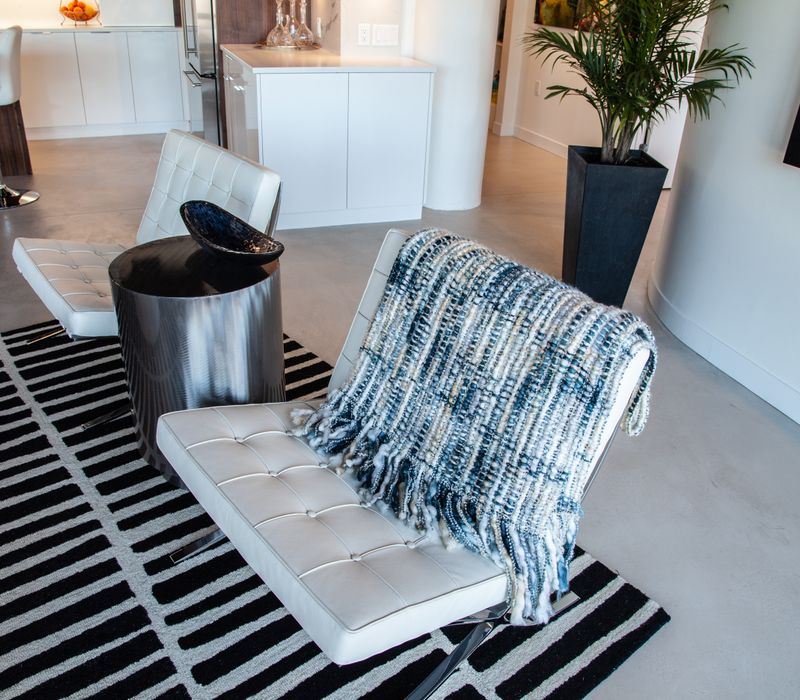 White and stainless steel dominate in this minimalist condo showcasing contemporary artwork. 