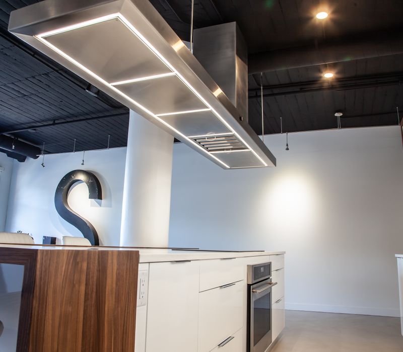 White and stainless steel dominate in this minimalist condo showcasing contemporary artwork. 