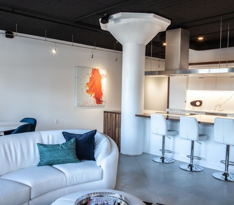 White and stainless steel dominate in this minimalist condo showcasing contemporary artwork. 