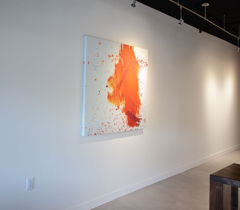 White and stainless steel dominate in this minimalist condo showcasing contemporary artwork. 