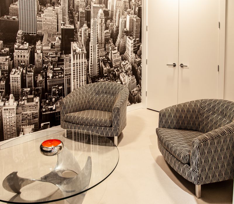 White and stainless steel dominate in this minimalist condo showcasing contemporary artwork. 