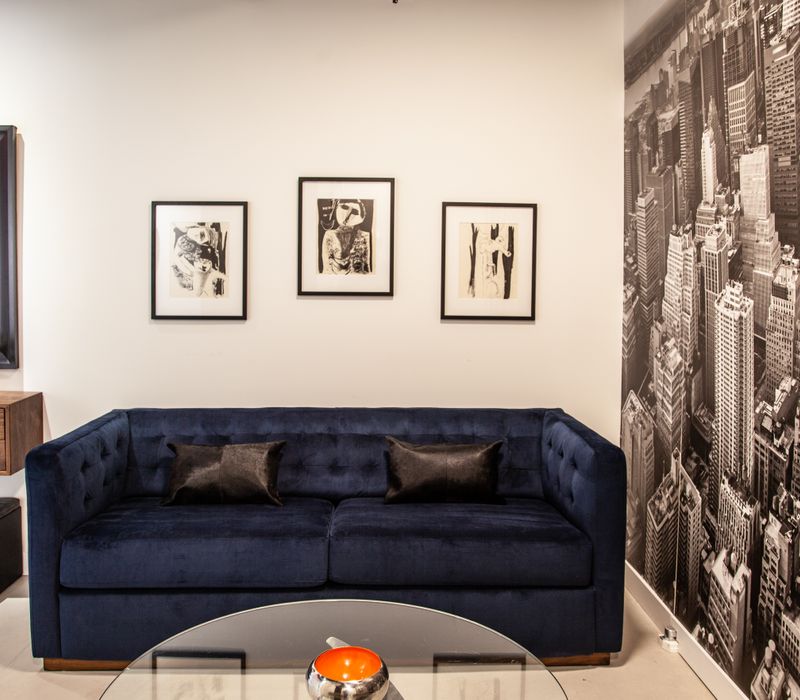 White and stainless steel dominate in this minimalist condo showcasing contemporary artwork. 