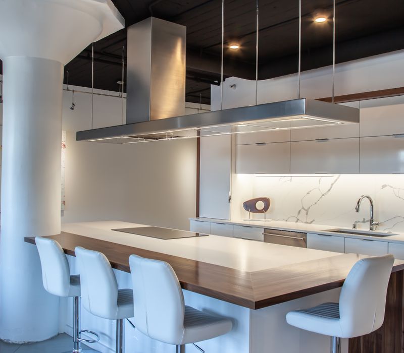 White and stainless steel dominate in this minimalist condo showcasing contemporary artwork. 