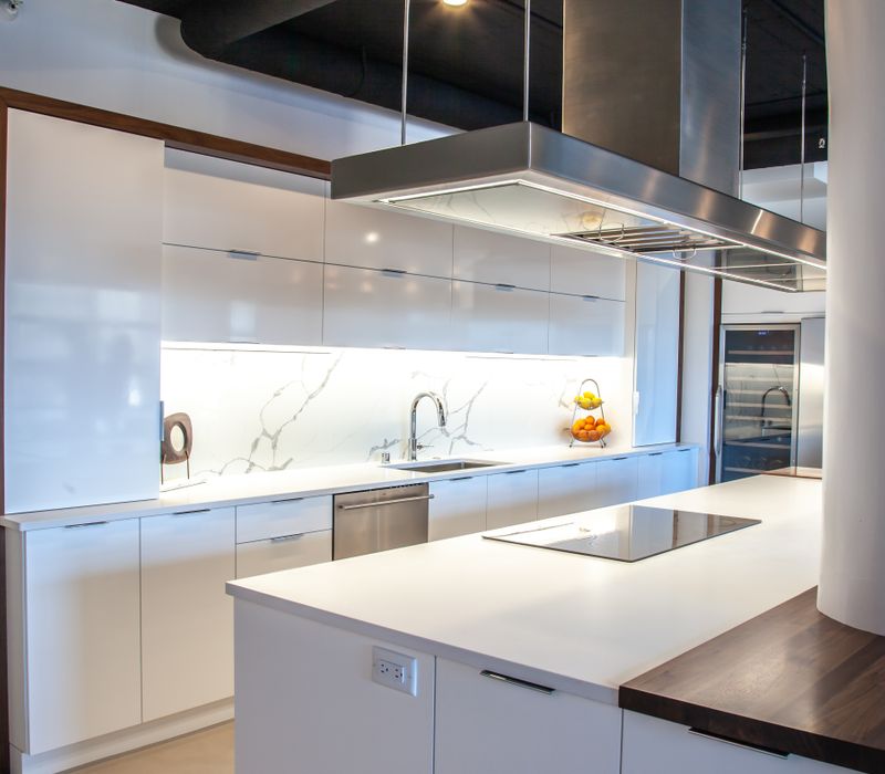 White and stainless steel dominate in this minimalist condo showcasing contemporary artwork. 