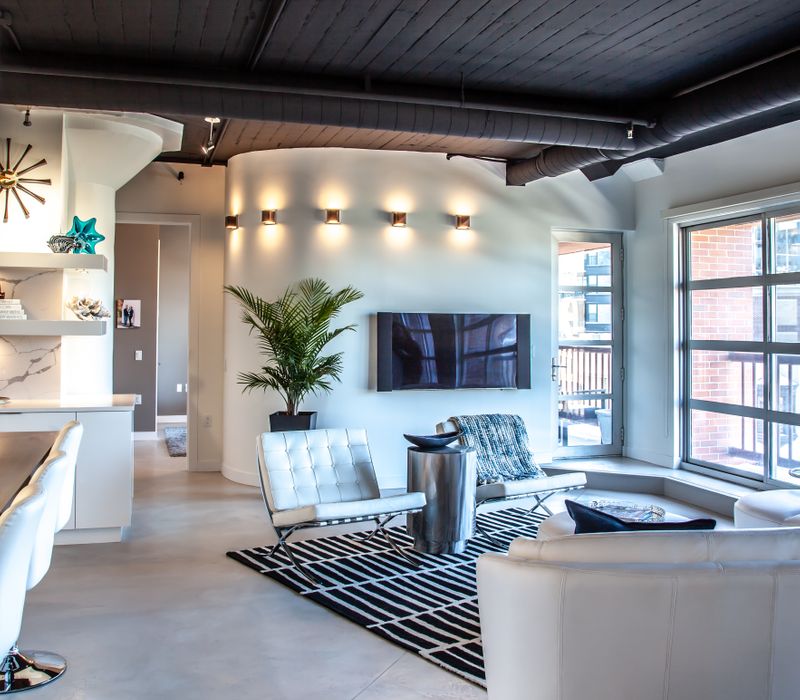 White and stainless steel dominate in this minimalist condo showcasing contemporary artwork. 