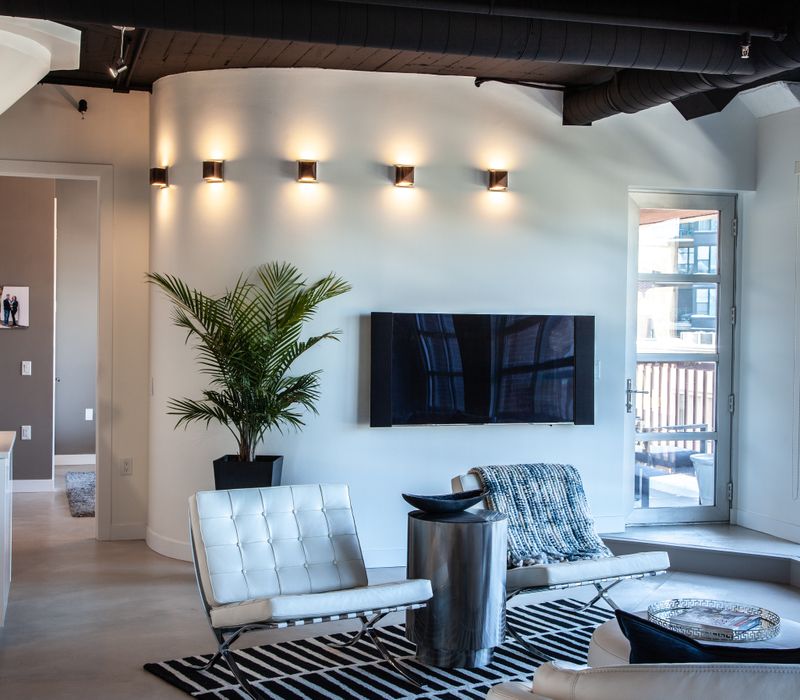 White and stainless steel dominate in this minimalist condo showcasing contemporary artwork. 