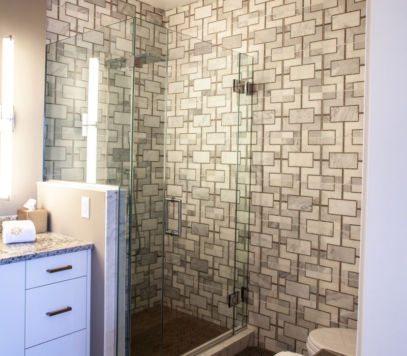 White and stainless steel dominate in this minimalist condo showcasing contemporary artwork. 