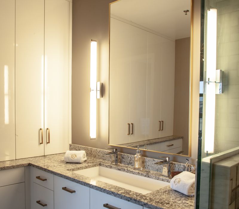 White and stainless steel dominate in this minimalist condo showcasing contemporary artwork. 