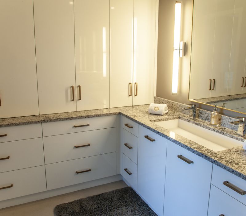 White and stainless steel dominate in this minimalist condo showcasing contemporary artwork. 