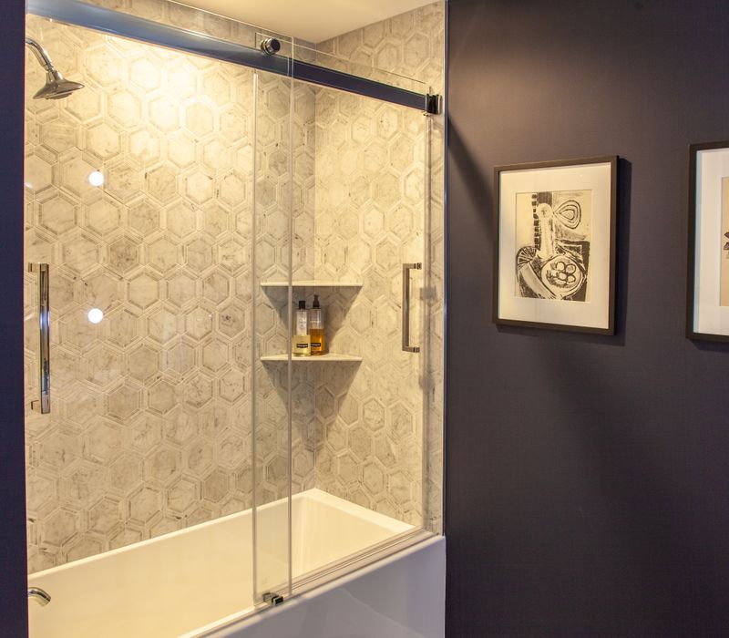 White and stainless steel dominate in this minimalist condo showcasing contemporary artwork. 