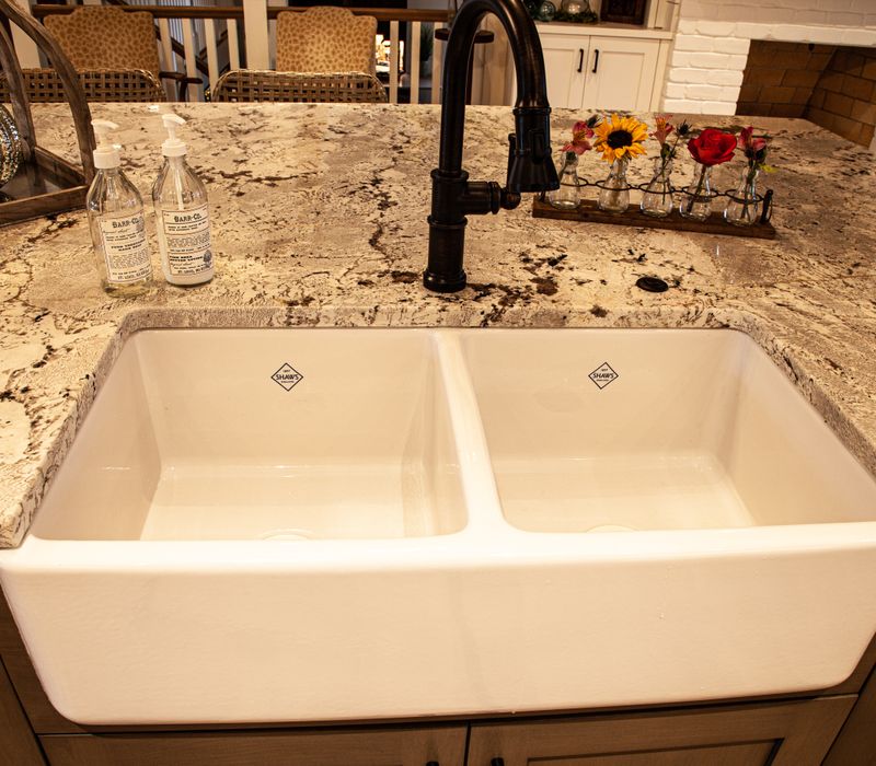 This country home has a rustic chic style with rough-hewn exposed wood beams, hand-painted terra cotta tiles, and a stone turret.