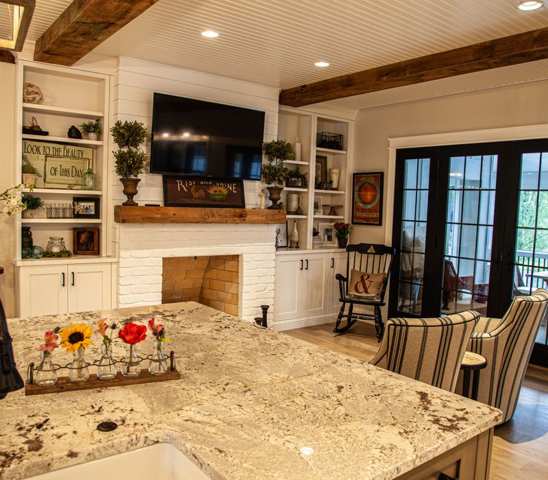 This country home has a rustic chic style with rough-hewn exposed wood beams, hand-painted terra cotta tiles, and a stone turret.