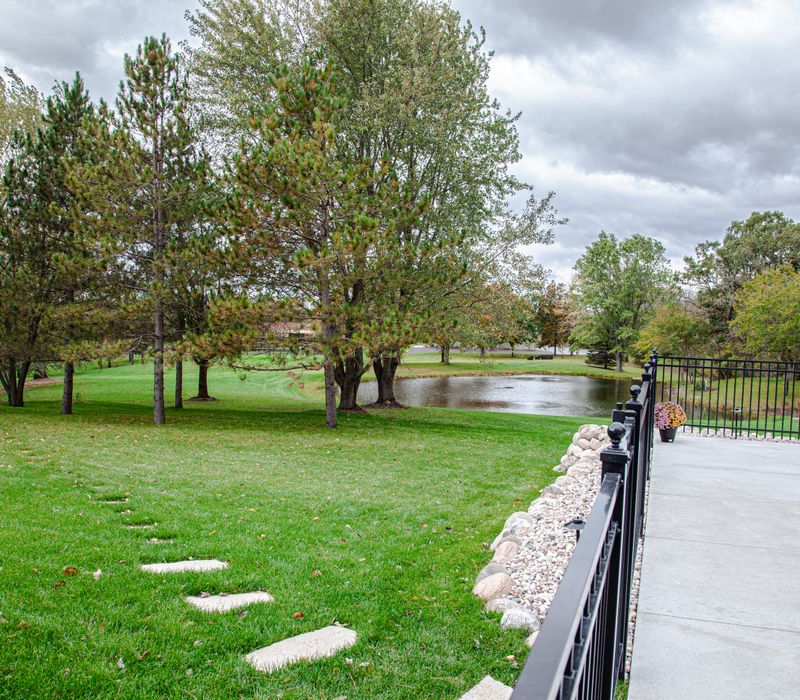 This country home has a rustic chic style with rough-hewn exposed wood beams, hand-painted terra cotta tiles, and a stone turret.