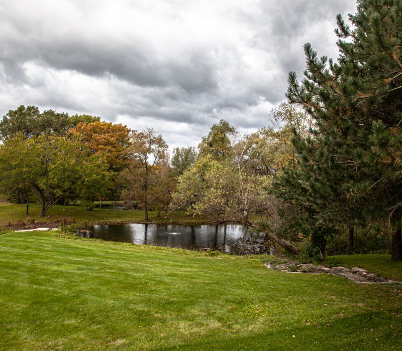 This country home has a rustic chic style with rough-hewn exposed wood beams, hand-painted terra cotta tiles, and a stone turret.