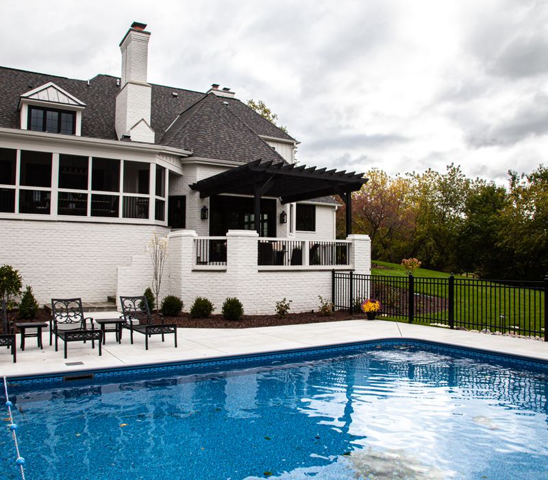 This country home has a rustic chic style with rough-hewn exposed wood beams, hand-painted terra cotta tiles, and a stone turret.
