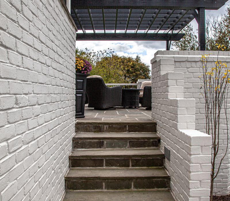 This country home has a rustic chic style with rough-hewn exposed wood beams, hand-painted terra cotta tiles, and a stone turret.