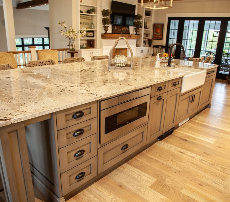 This country home has a rustic chic style with rough-hewn exposed wood beams, hand-painted terra cotta tiles, and a stone turret.