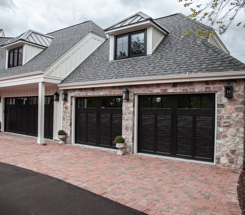 This country home has a rustic chic style with rough-hewn exposed wood beams, hand-painted terra cotta tiles, and a stone turret.
