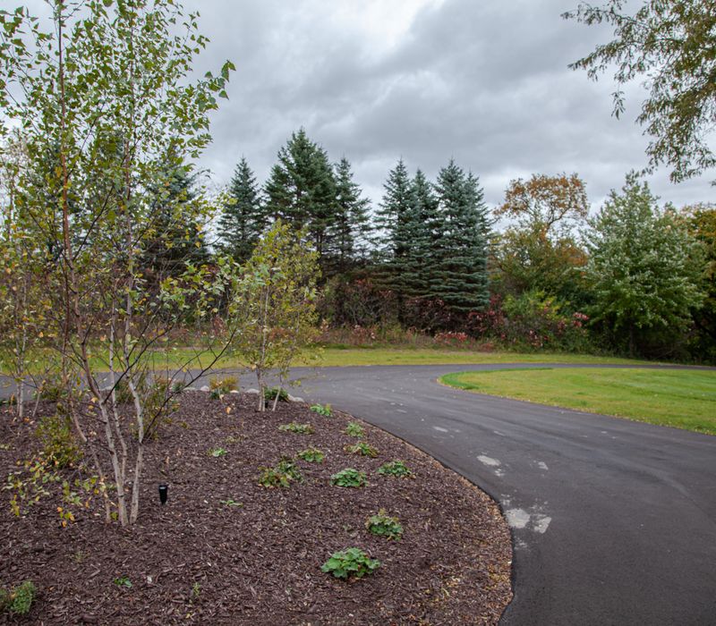 This country home has a rustic chic style with rough-hewn exposed wood beams, hand-painted terra cotta tiles, and a stone turret.