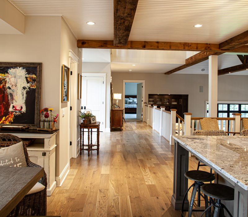 This country home has a rustic chic style with rough-hewn exposed wood beams, hand-painted terra cotta tiles, and a stone turret.