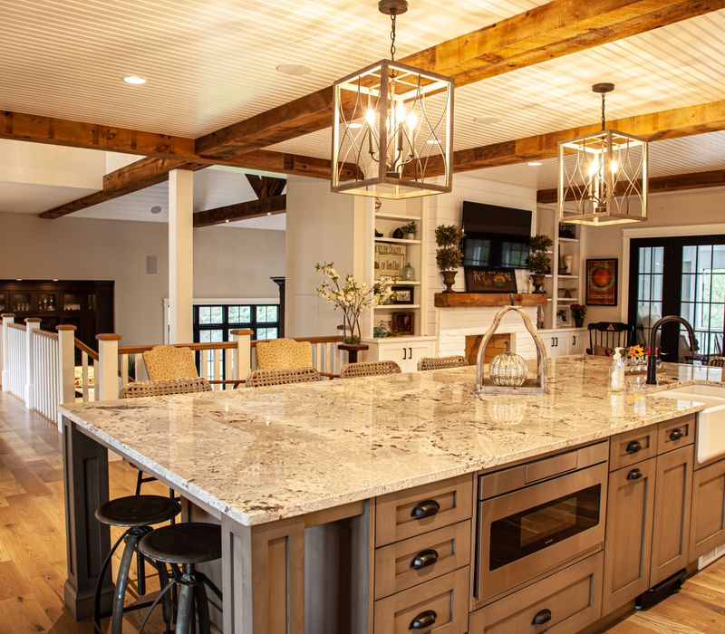 This country home has a rustic chic style with rough-hewn exposed wood beams, hand-painted terra cotta tiles, and a stone turret.