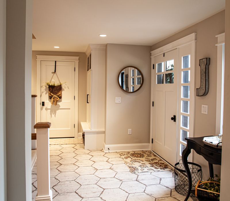 This country home has a rustic chic style with rough-hewn exposed wood beams, hand-painted terra cotta tiles, and a stone turret.